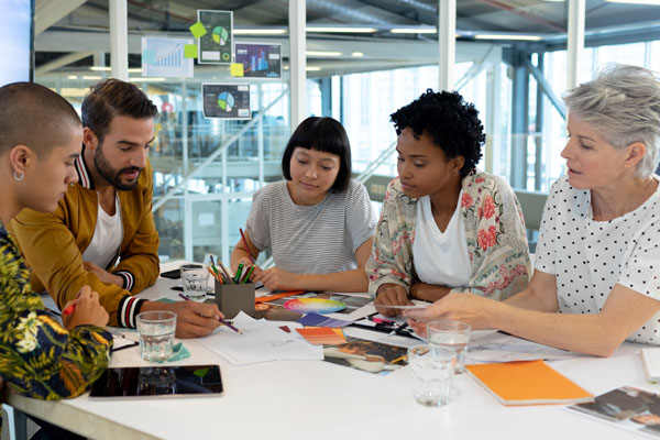 People discussing work at a table